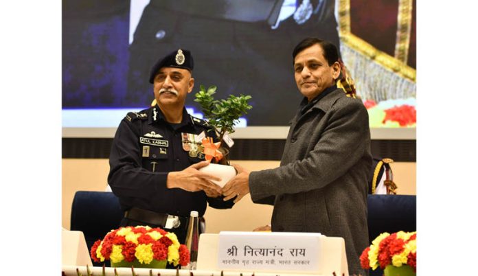 Union Minister of State for Home Affairs Nityanand Rai being presented a memento by Director General NDRF Atul Karwal at the National Disaster Response Force (NDRF) raising day celebration, in New Delhi on Friday. (UNI)