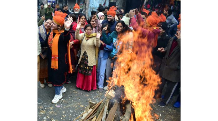 People celebrating Lohri festival in Jammu on Saturday.