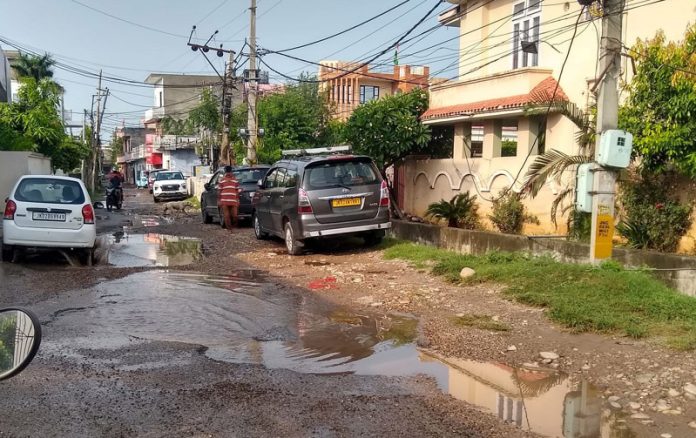 Dilapidated road in Om Nagar area of Jammu.