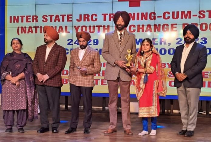 A student from Jammu receiving award during an event in Punjab.