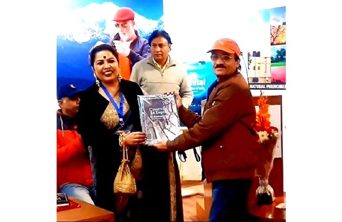 Sculptor Ganesh Kumar Sharma receives award during a function at New Delhi.