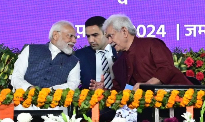 LG Manoj Sinha discusses a point with PM Narendra Modi during a massive rally at MA Stadium in Jammu on Tuesday.