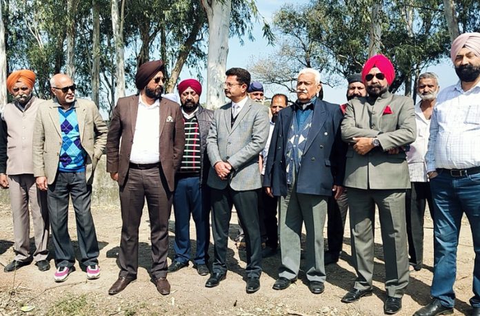 Taranjit Singh Tony posing along with members of Jammu and Kashmir Rifle Association at Suchetgarh on Tuesday.