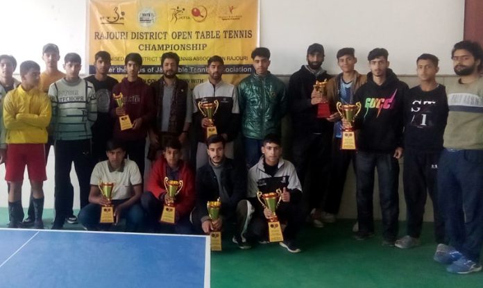 Table Tennis players posing along with trophies at Rajouri on Tuesday.