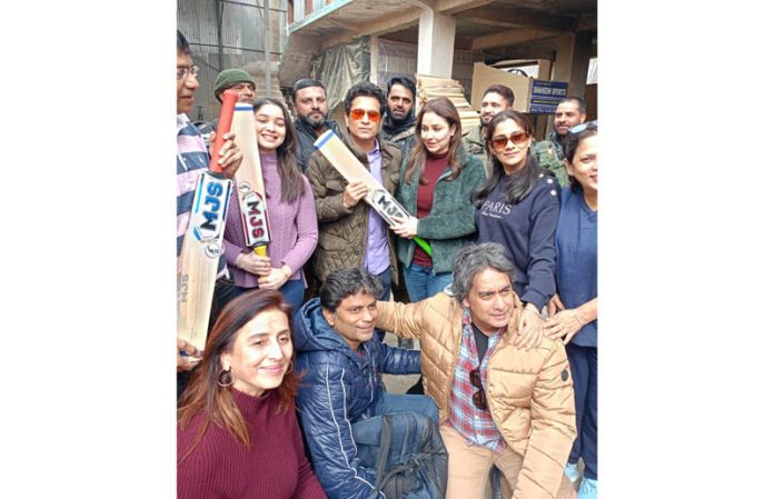 God of cricket Sachin Tendulkar alongwith family displaying bats while posing for a group photograph at Chersoo Awantipora in Pulwama district on Saturday. -Excelsior/Sajad Dar