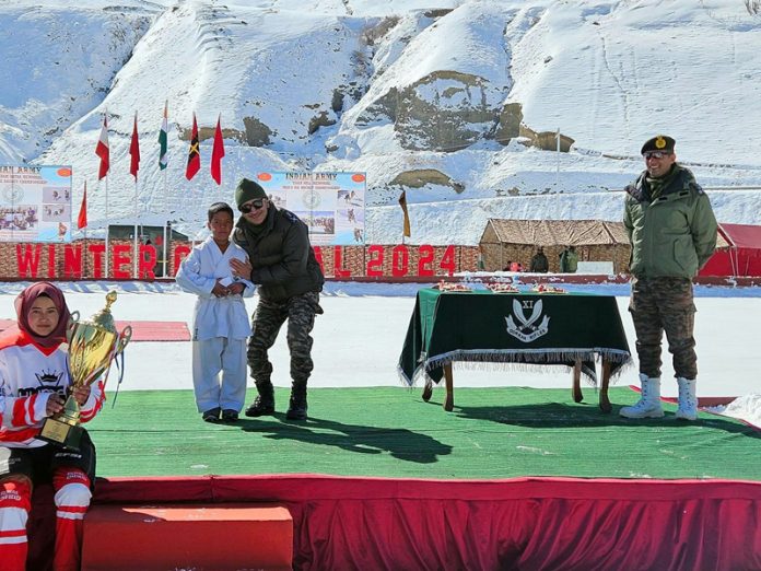 An Army officer posing with players during Drass Winter Carnival 2024 on Tuesday. -Excelsior/Basharat Ladakhi