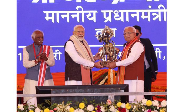 Prime Minister Narendra Modi being presented a memento by Haryana Chief Minister Manohar Lal Khattar at Rewari on Friday. (UNI)