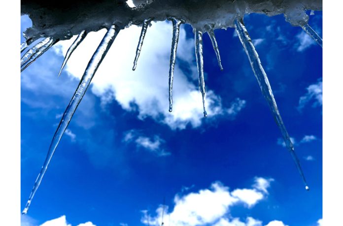 Icicles hang from a residential house in Kulgam district of Kashmir on Monday. (UNI)