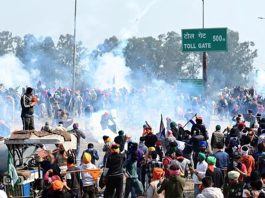 Haryana Police fires teargas shells to stop protesters at Shambhu border of Punjab and Haryana near Ambala on Wednesday.