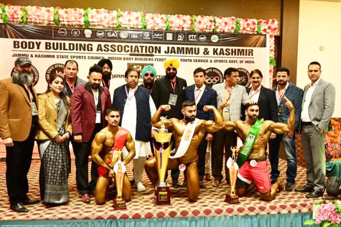 Senior Congress leader Raman Bhalla posing along with Body Builders in Jammu on Sunday.