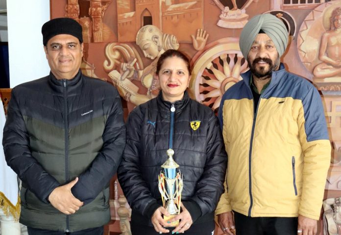 Preeti Gupta Badminton coach posing with trophy along with dignitaries.