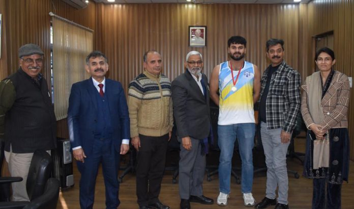 Powerlifter Sumit Thakyal posing with Vice-Chancellor, Cluster University of Jammu, Prof. Bechan Lal on Friday.