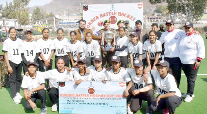 Hockey team posing along with trophy at Poonch on Wednesday.