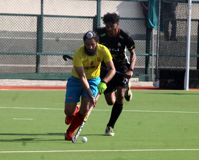 Players in action during quarterfinal match at KK Hakku Hockey Stadium in Jammu on Monday. -Excelsior/Rakesh