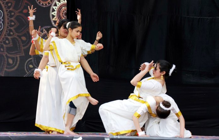 Students performing on cultural item during a programme.