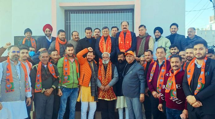 Senior BJP leaders taking new entrants into party fold during a meeting at Kathua on Monday.