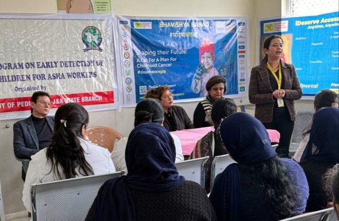 Medical experts delivering talk on early detection of cancer in children during awareness camp for ASHA workers.