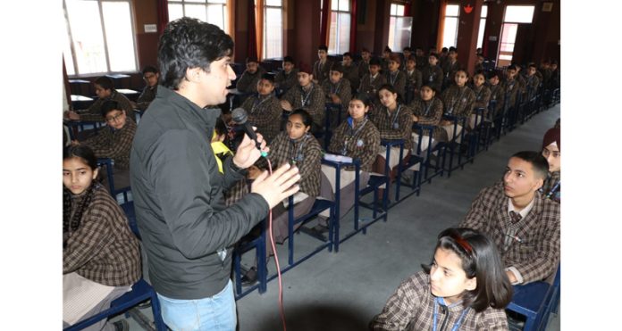 A teacher delivering lecture during a Quiz contest.