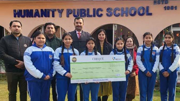 Humanity Public School Principal, Gaurav Charak posing with students along with a cheque of Rs 10,000.