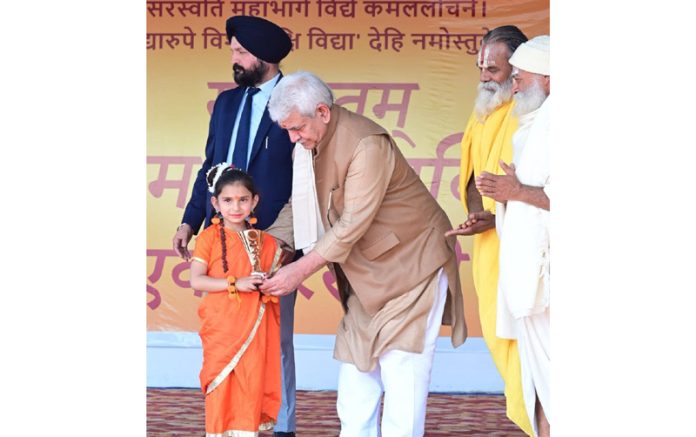 Lieutenant Governor, Manoj Sinha presenting trophy to a little girl for her outstanding presentation of cultural item on Thursday.