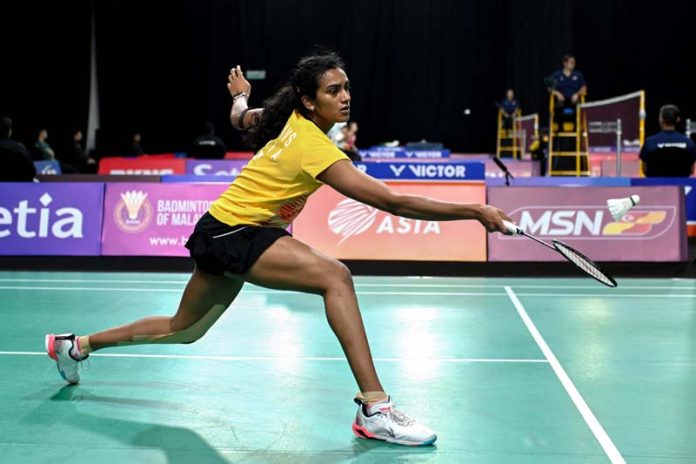 Venkata Sindhu Pusarla of India hits a return during the women's singles match against Han Yue of China in Shah Alam, Selangor, Malaysia on Wednesday.