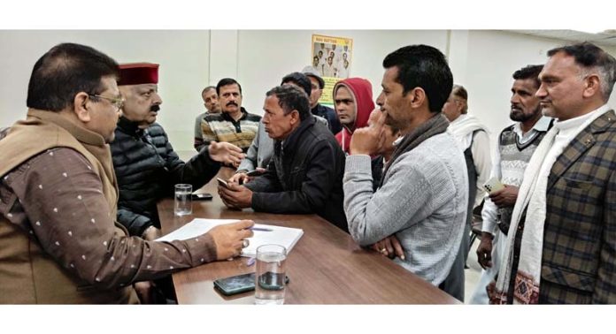 Senior BJP leader Devender Singh Rana listening public grievances at BJP headquarters on Friday.