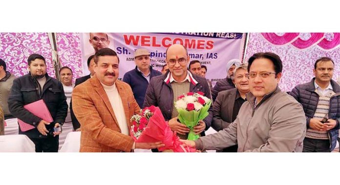 Secretary PWD Bhupinder Kumar being presented bouquet during grievances redressal camp at Reasi on Friday.