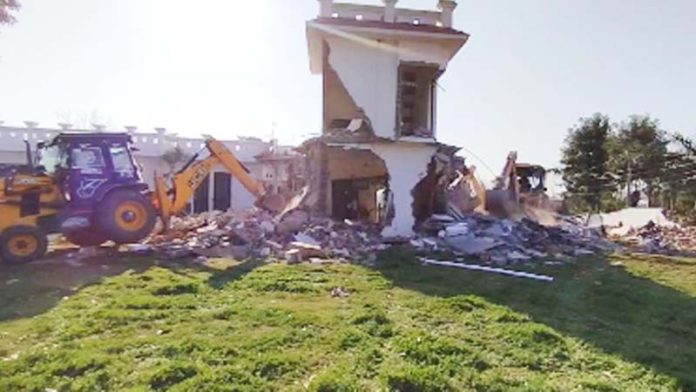 A building running illegal de-addiction centre being demolished in Birpur, Samba on Wednesday. -Excelsior/Nischant