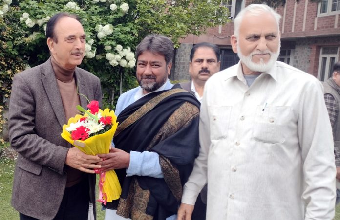 DPAP Chairman Ghulam Nabi Azad being felicitated during visit to Budgam by provincial general secretary, Nazir Yatoo on Thursday.