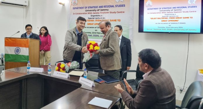 Prof Virender Koundal receiving resource person Col (Retd) Ajay K Raina at public lecture in JU.