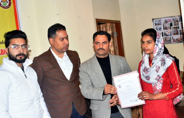 Deputy Commissioner Rajouri Om Prakash Bhagat presenting certificate to a student on Friday.