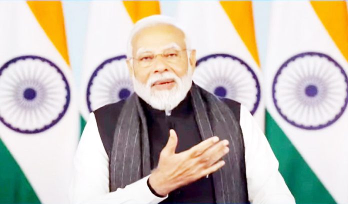 Prime Minister Narendra Modi digitally addresses the Viksit Bharat Viksit Gujarat programme, in New Delhi on Saturday. (tv grab) (UNI)
