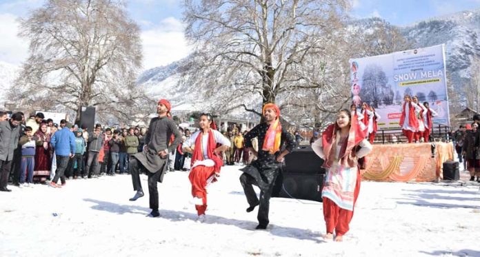 Artists present a dance item during the event 'Snow Mela' in Kishtwar on Monday.