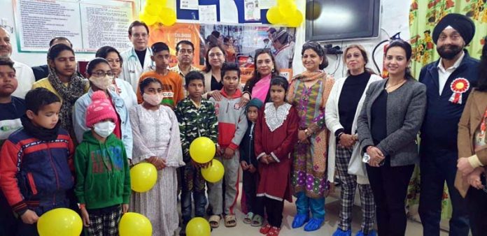 Ritu Singh and representatives of other NGOs posing with children and doctors during a function at Pediatric Oncology Ward in SMGS Hospital, Jammu.