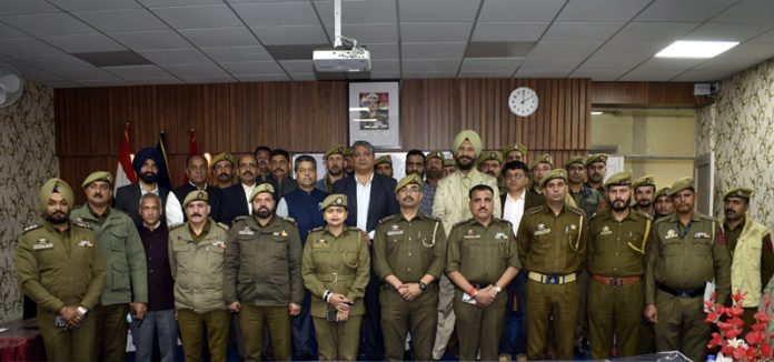 Police personnel along with others posing for a group photograph on culmination of a training programme at PTTI Vijaypur.