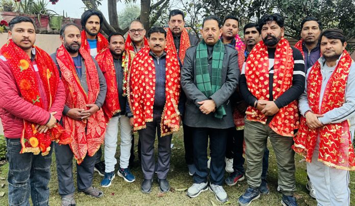 Former Dy Mayor, Jammu, Baldev Singh Billawaria posing for a photograph with newly elected members of Gangyal Shopkeepers Association on Wednesday.