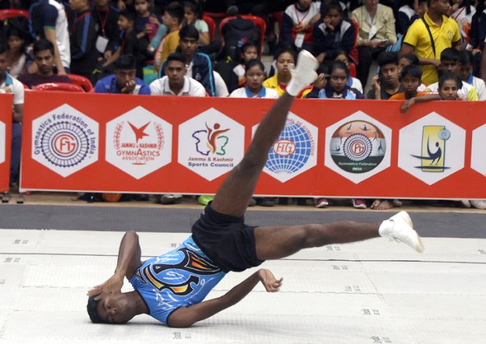 A gymnast displaying his skills during ongoing National Aerobic Gymnastics Championship at MA Stadium Jammu on Saturday. -Excelsior/Rakesh