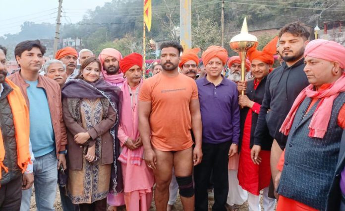 Sanjeev Verma Commissioner Secretary GAD, Sunaina Sharma Mehta Joint Director Tourism along with others posing with wrestler during concluding function at Peer Kho Jammu.