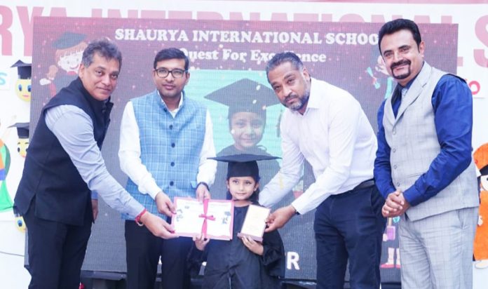 Jammu Municipal Corporation Commissioner Rahul Yadav presenting certificates to a toddler during a school event on Tuesday.