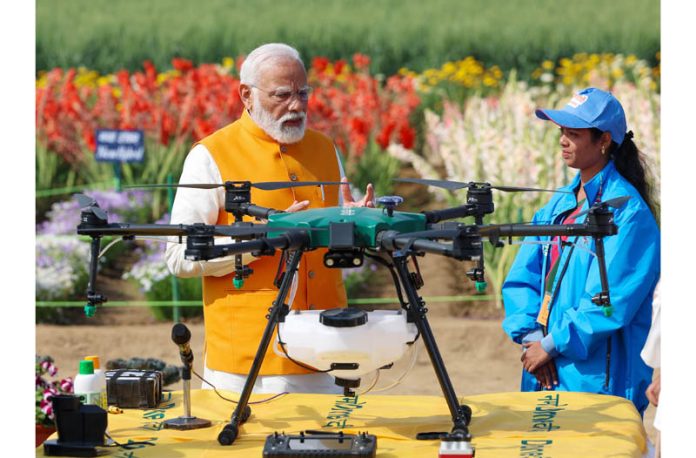 Prime Minister Narendra Modi witnessing agricultural drone demonstrations by Namo Drone Didis during Sashakt Nari - Viksit Bharat programme at Indian Agricultural Research Institute, Pusa in New Delhi on Monday. (UNI)