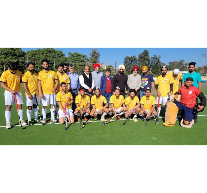 Hockey players posing with dignitaries during an exhibition match at Jammu on Friday.