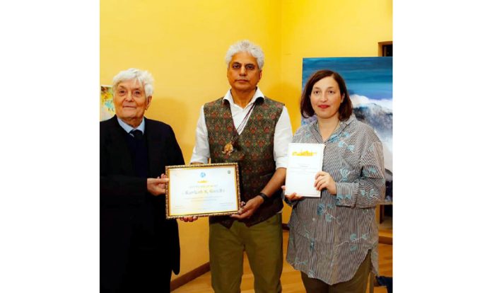 Renowned artist, K.K Gandhi receives a certificate during an art function in Rome.