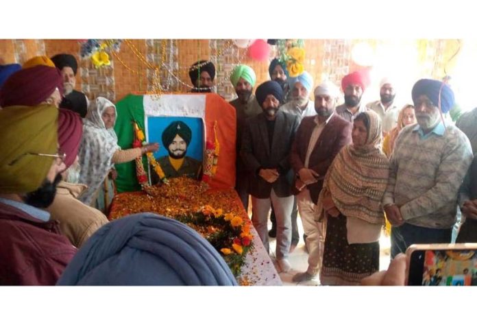 Manjit Singh and others paying tribute to the Kargil war martyr.