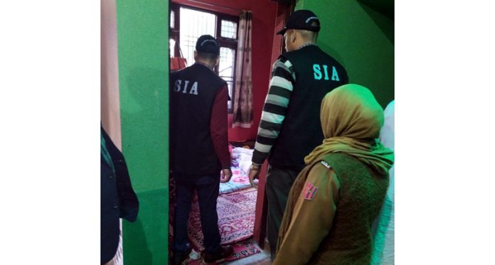 SIA sleuths searching a house on Friday.