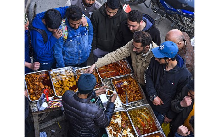 People buy Wazwan-e-Anchar (pickles) on a roadside stall during the holy month of Ramadan in downtown Srinagar. —Excelsior/Shakeel