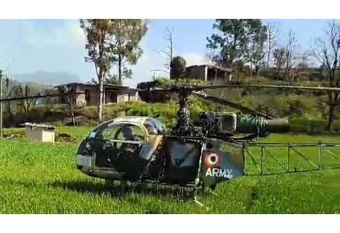 Army helicopter during landing in a field at Sunderbani.
