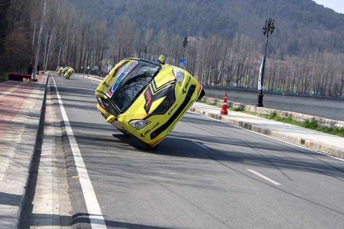 Cars running in full speed during the Formula-4 race held on Boulevard Road along Dal lake in Srinagar on Sunday. -Excelsior/Shakeel