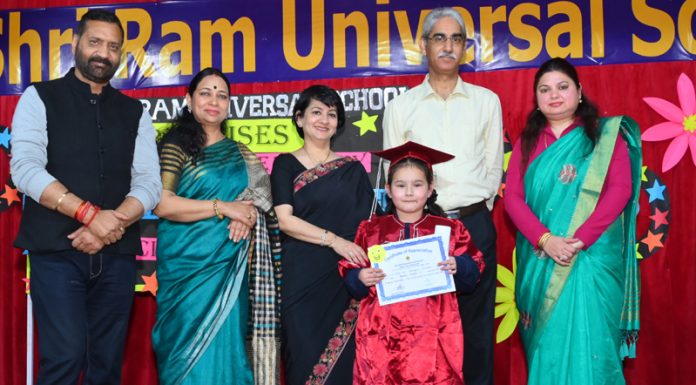 A student displaying certificate while posing with dignitaries during a programme at school on Thursday.