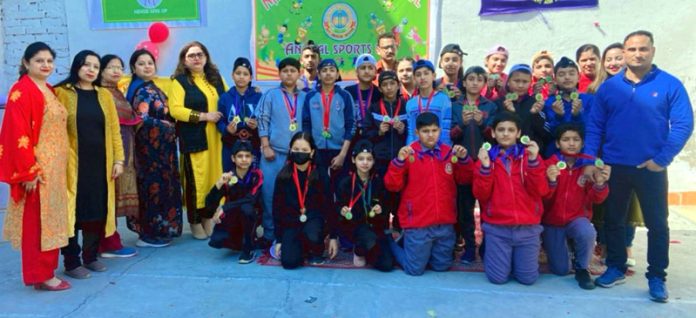 Students of Nav Yug Higher Secondary School posing along with medals.