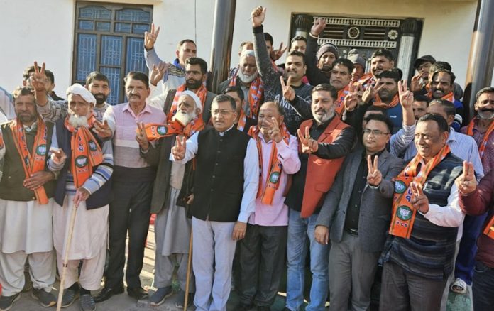 New entrants who joined BJP posing for a photograph with BJP general secretary, Vibodh Gupta at village Dhanwa in Rajouri on Monday.